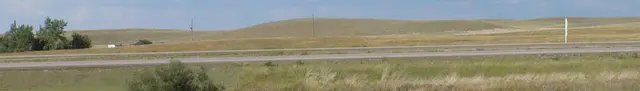 Rolling prairie hills beside the highway